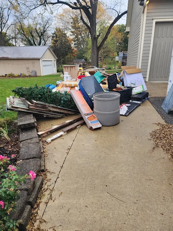 Dumpster being loaded with debris for 12 Yard Dumpster Rental in Leonardtown